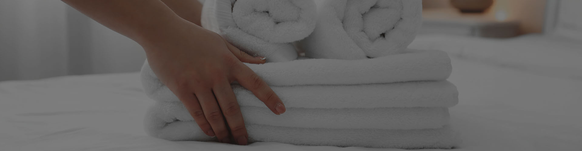 Image of person holding stack of clean towels