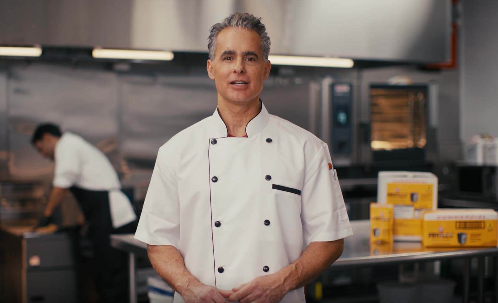 Chef in kitchen talking about FRYFLEX™